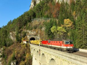 Two #alpenstaubsauger locomotives are rolling over the Krausel-Klause Viaduct with trackbed maintenance machinery on a beautiful autumn...